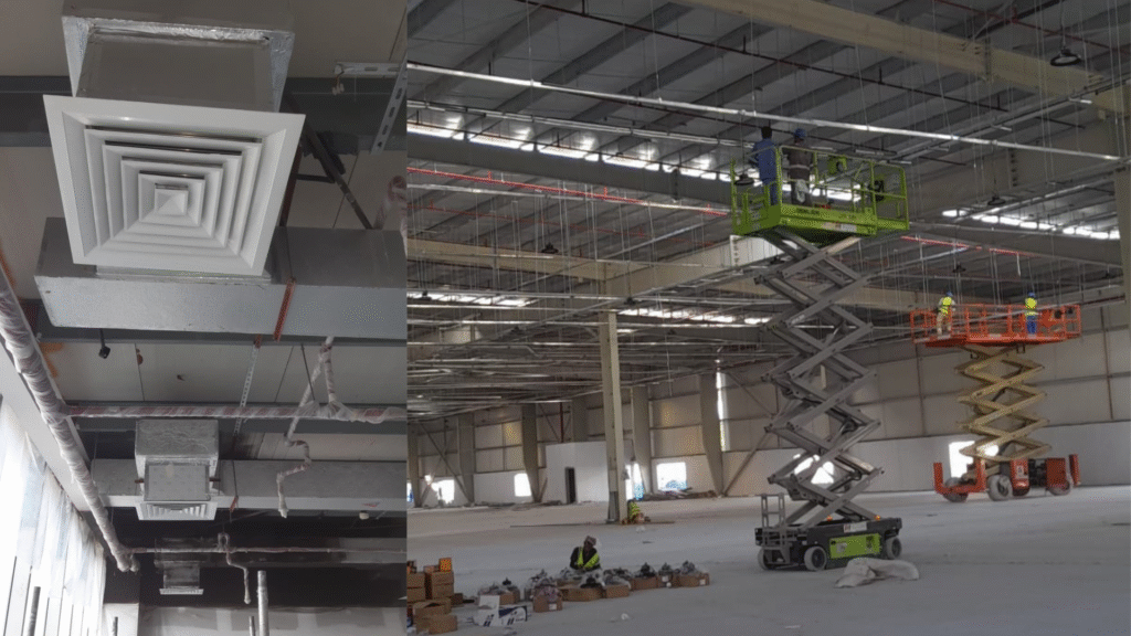 PPTS HVAC contractor team installing ductwork and ceiling ventilation systems using scissor lifts inside a large industrial facility.

